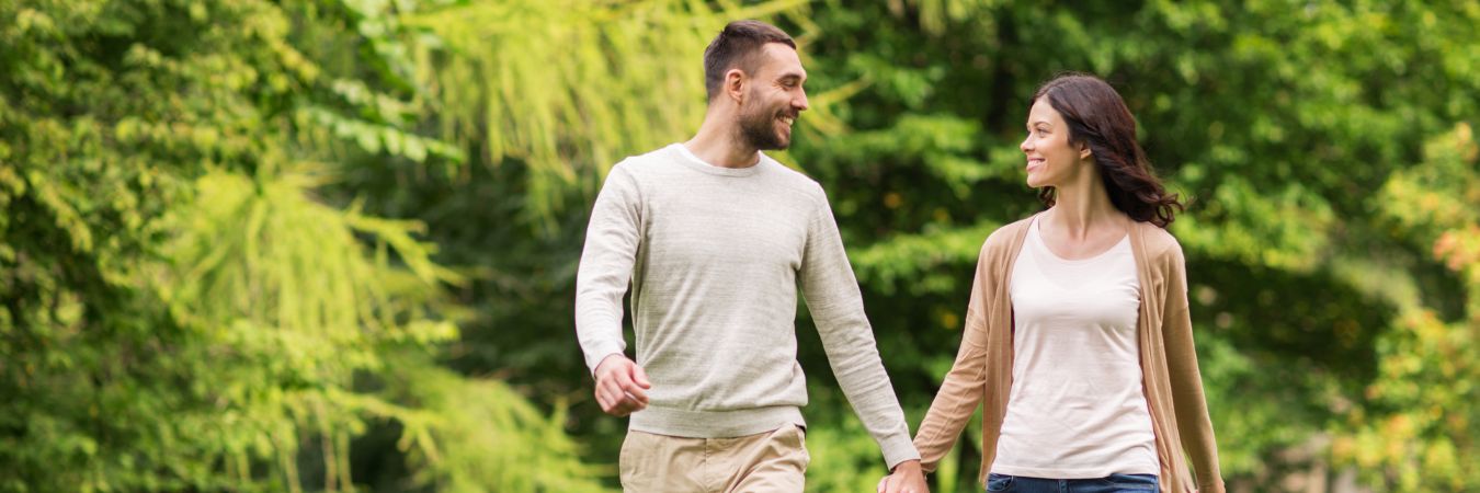  A couple walking hand in hand at a park during summer season enjoying life after rehab in Robbinsville 